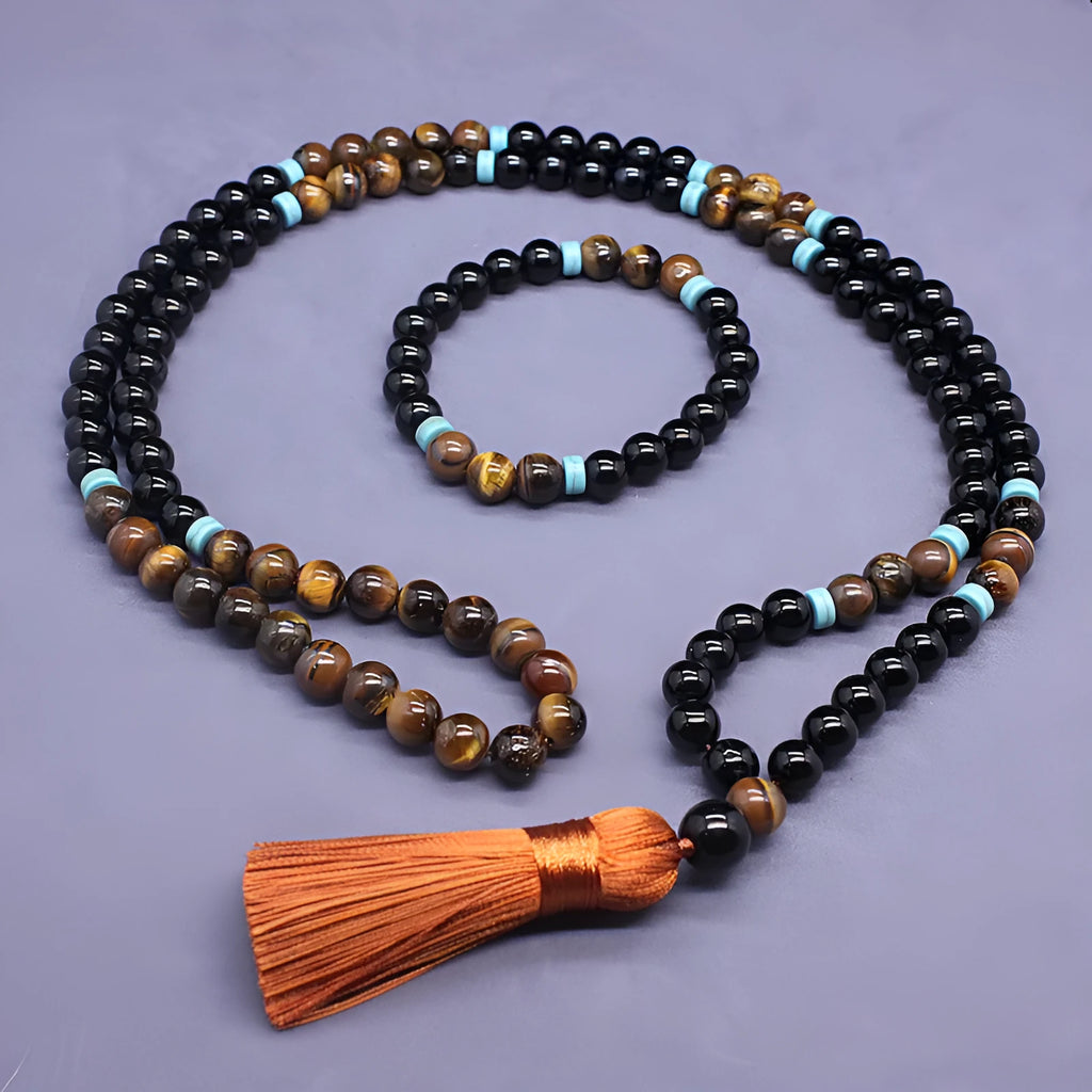 Black geometric agate bracelet and necklace set on a display background.