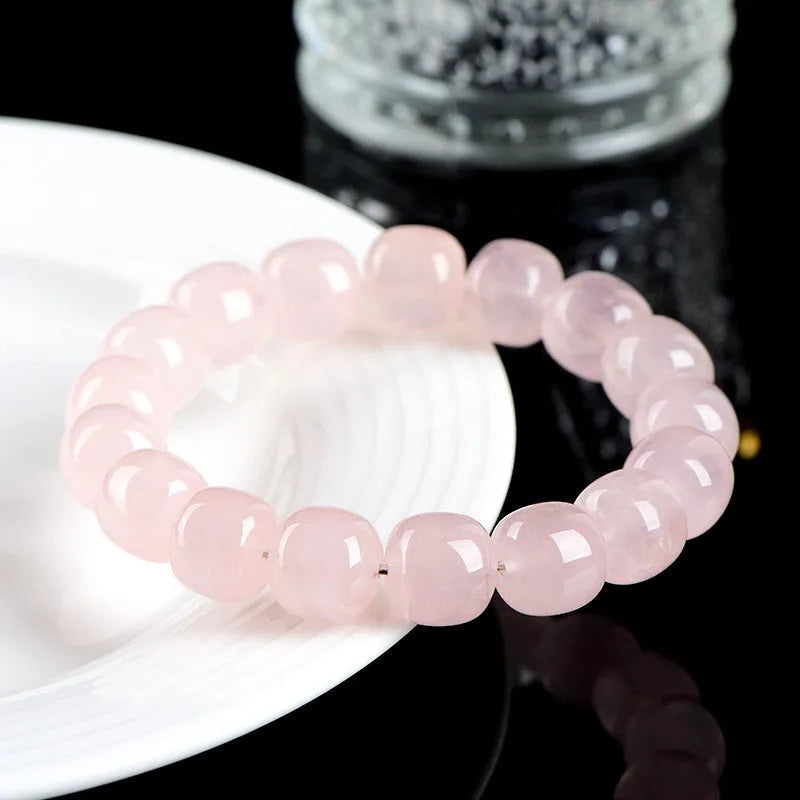 Pink bamboo crystal barrel bead bracelet with geometric 11mm-12mm beads on a wrist.