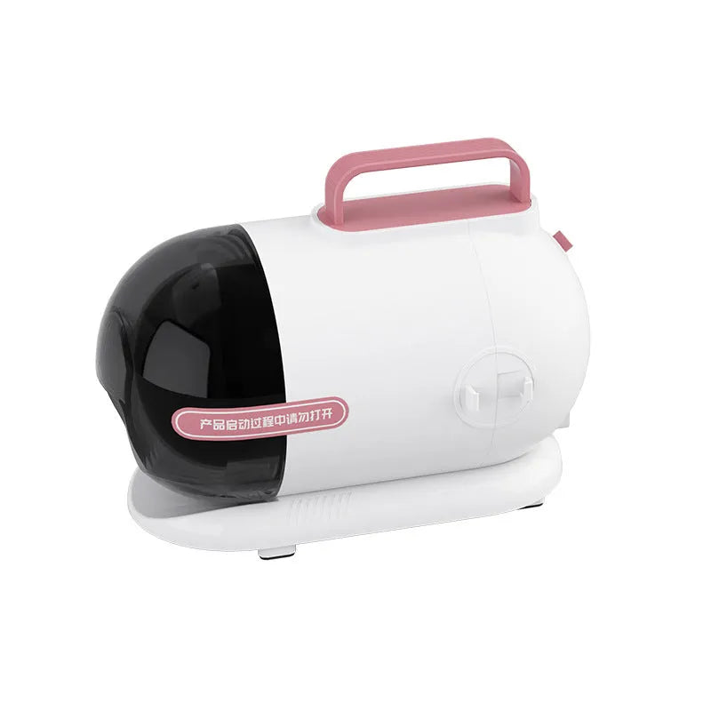 White and pink multifunctional pet grooming vacuum cleaner with clipper attachments on a table.