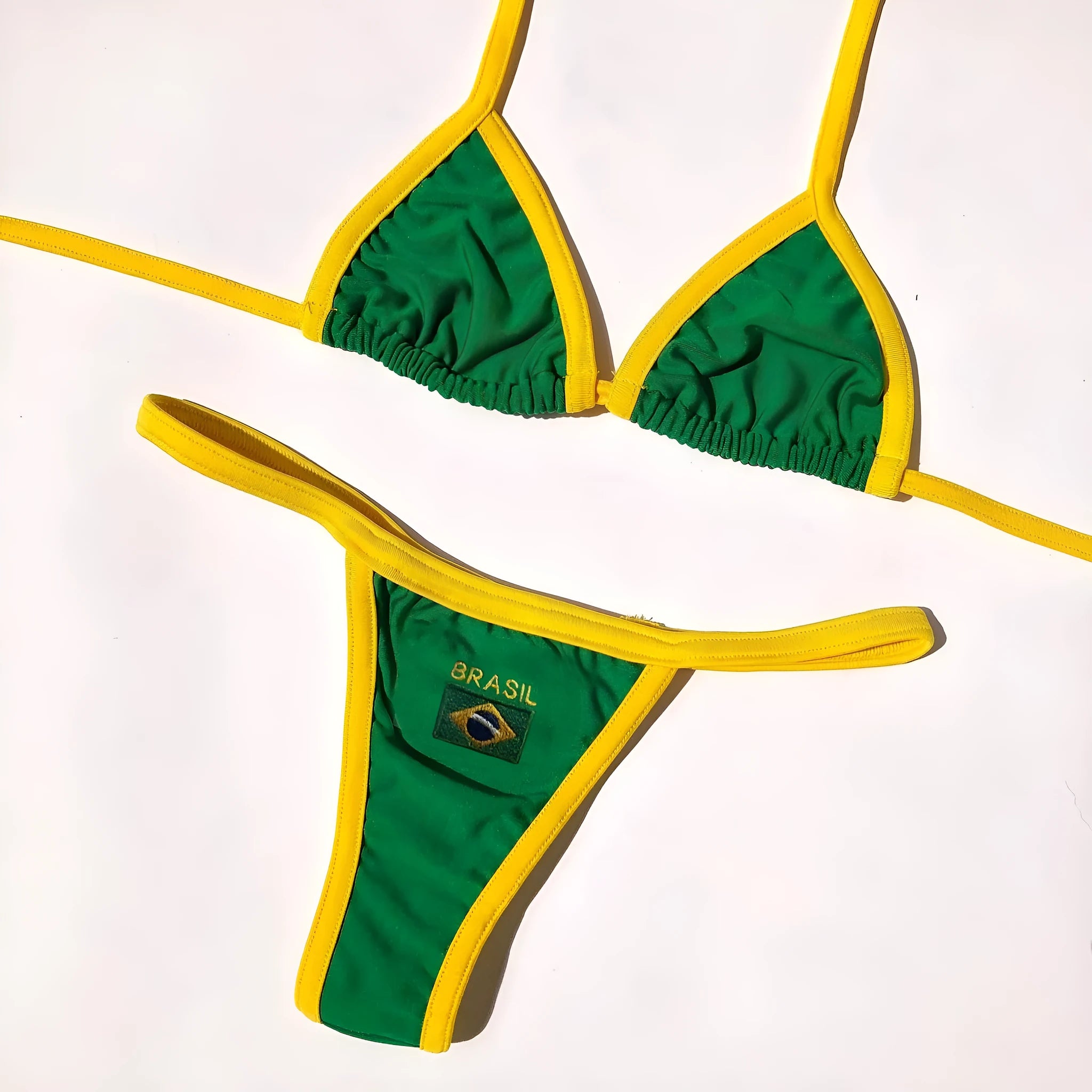 Women's yellow T-back bikini set with shorts-length bottoms laid flat.