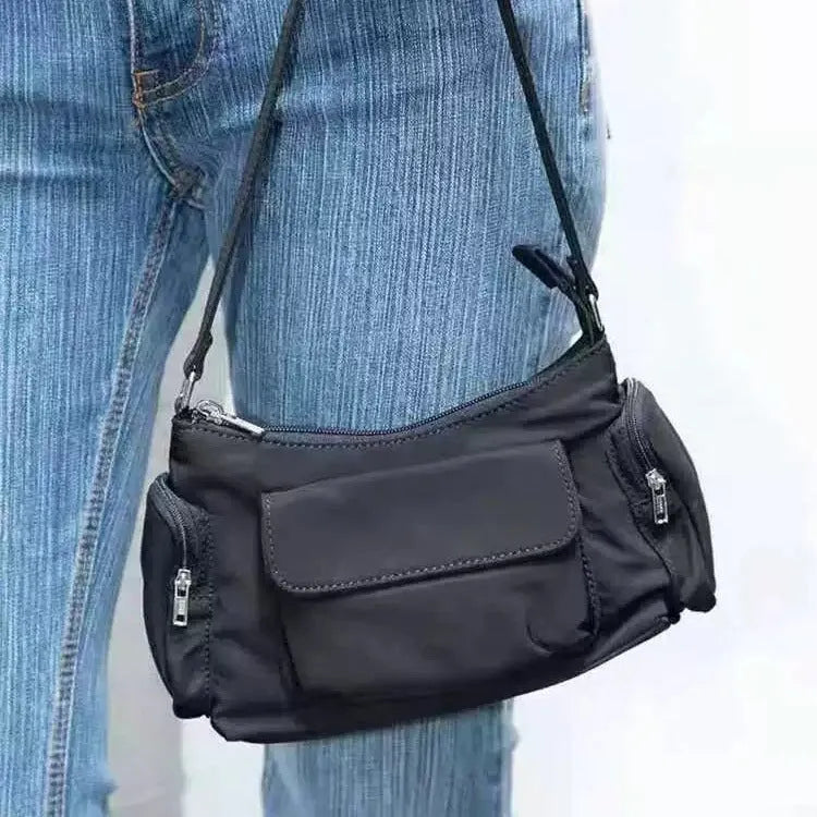 Black lightweight women's shoulder bag with double pockets and a side line design.