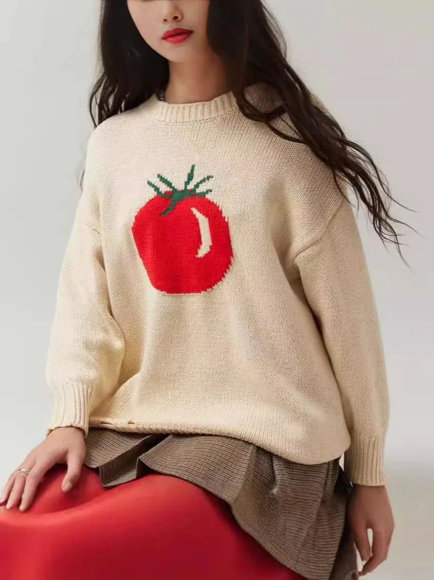 Women's beige loose-fit acrylic Jacquard knit sweater with round neck and long sleeves laid flat.