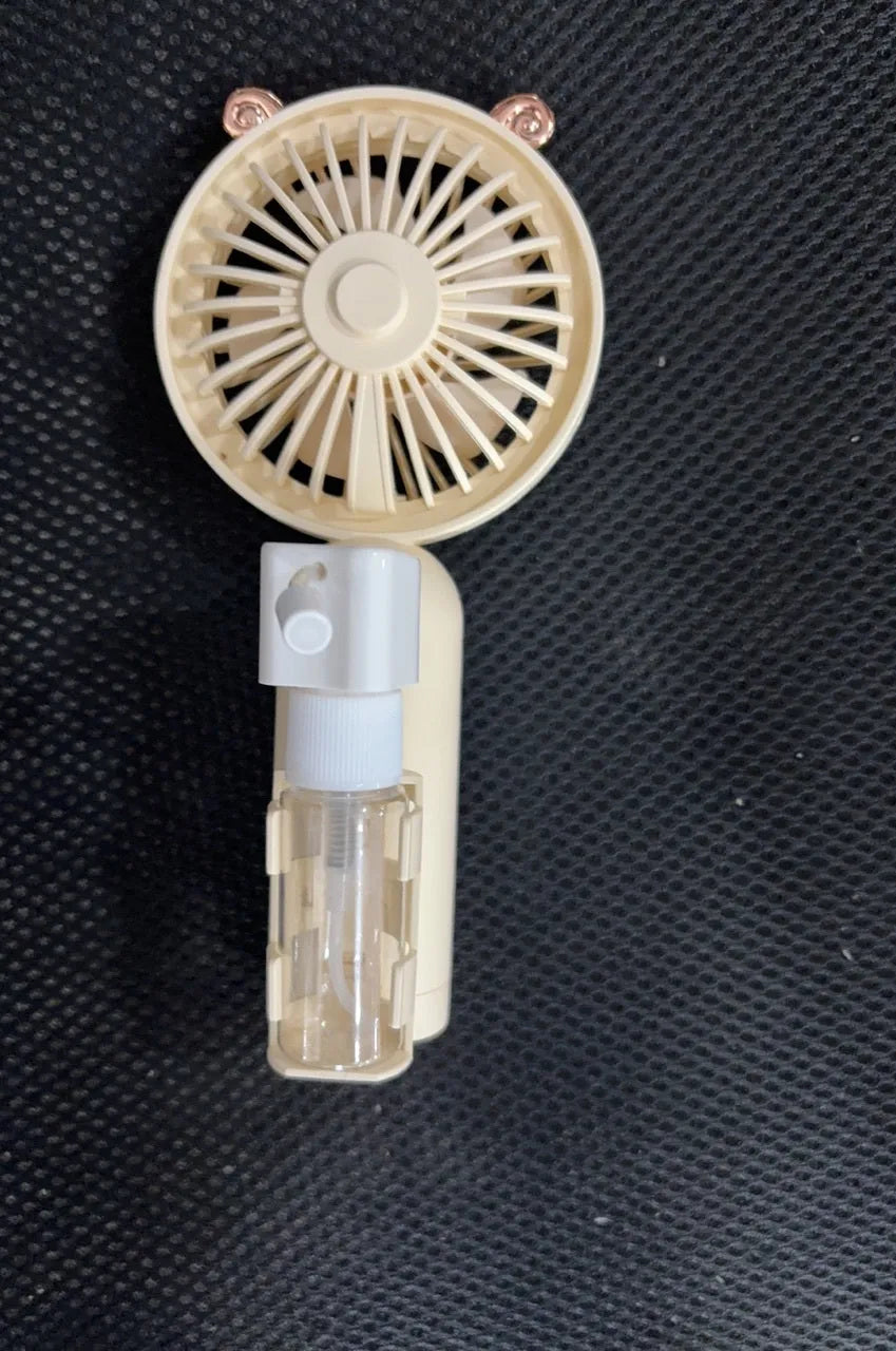 A handheld USB personal fan in one of five colours: apricot, blue, green, orange, or pink, showing its plastic nozzle and compact size.