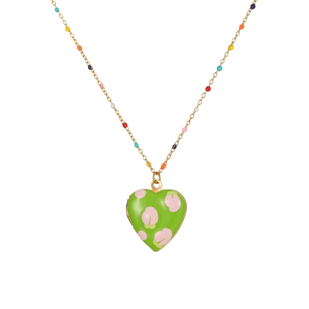 Gold-plated heart-shaped fruit pendant necklace on a stainless steel chain, showing grape design detail.
