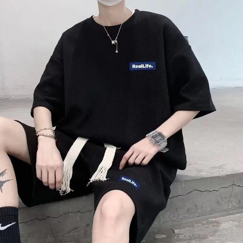 A waffle-textured leisure sports suit consisting of a short-sleeve top and shorts, shown in blue.