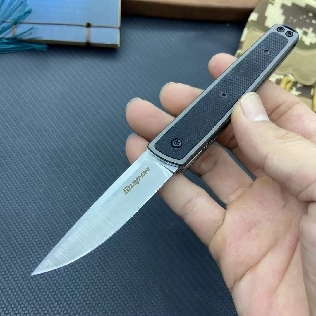 Closed and open views of a folding fruit knife with a coloured handle and stainless steel blade.