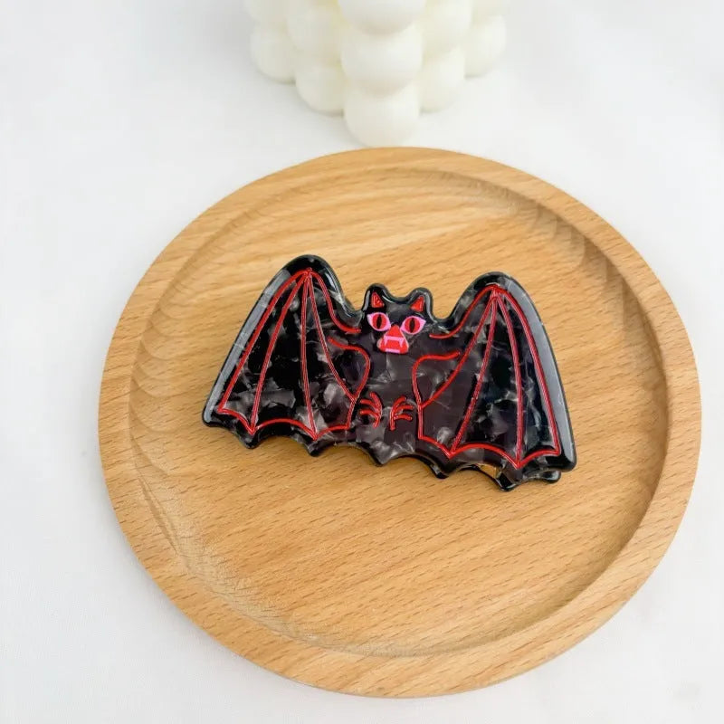 Handmade Halloween hair clip with bat design in four colour variations