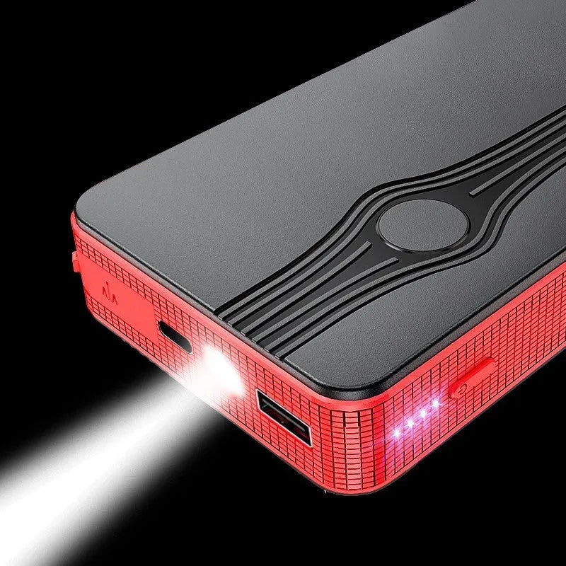 Red K4-E automobile emergency starting power supply and USB power bank unit on a grey surface.