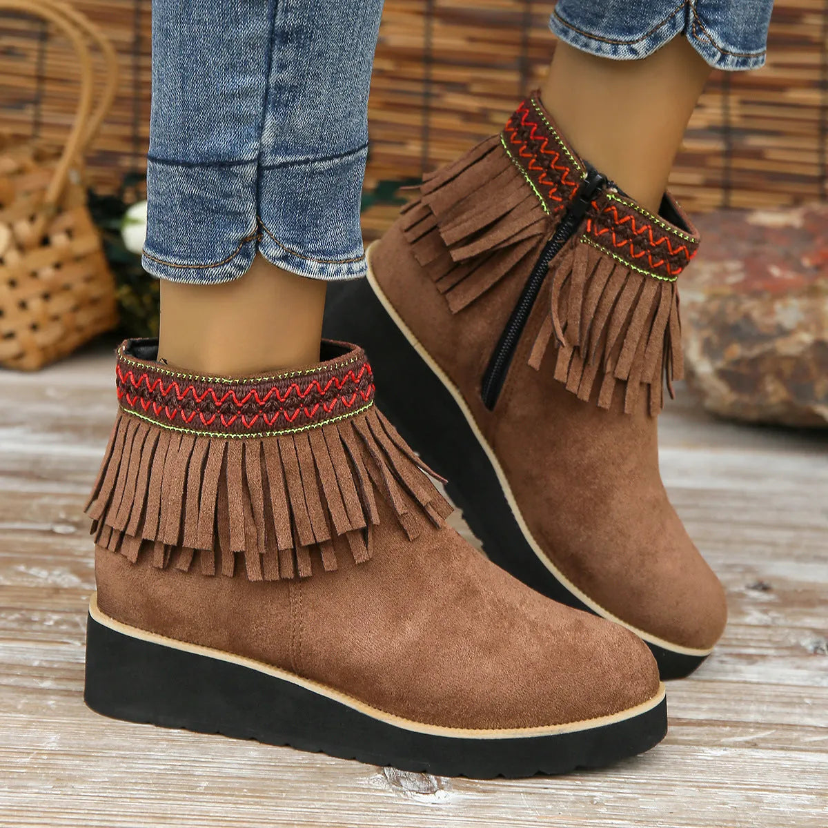 Women's dark brown suede wedge ankle boots with a side zipper and decorative tassel.