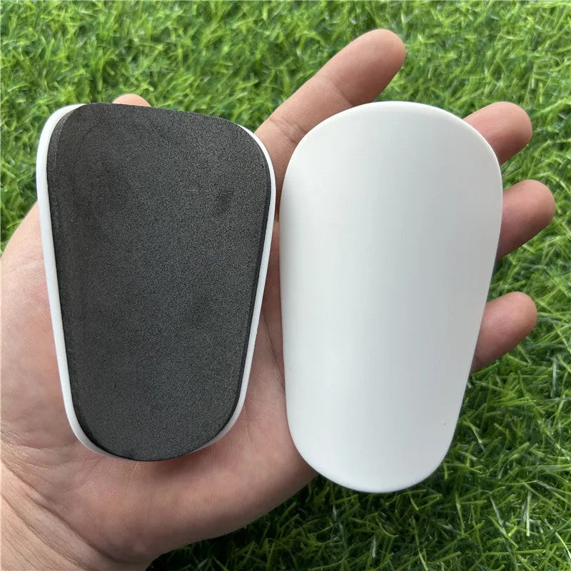 Extra small mini plastic football shin guards in black and white 8x5cm sizes