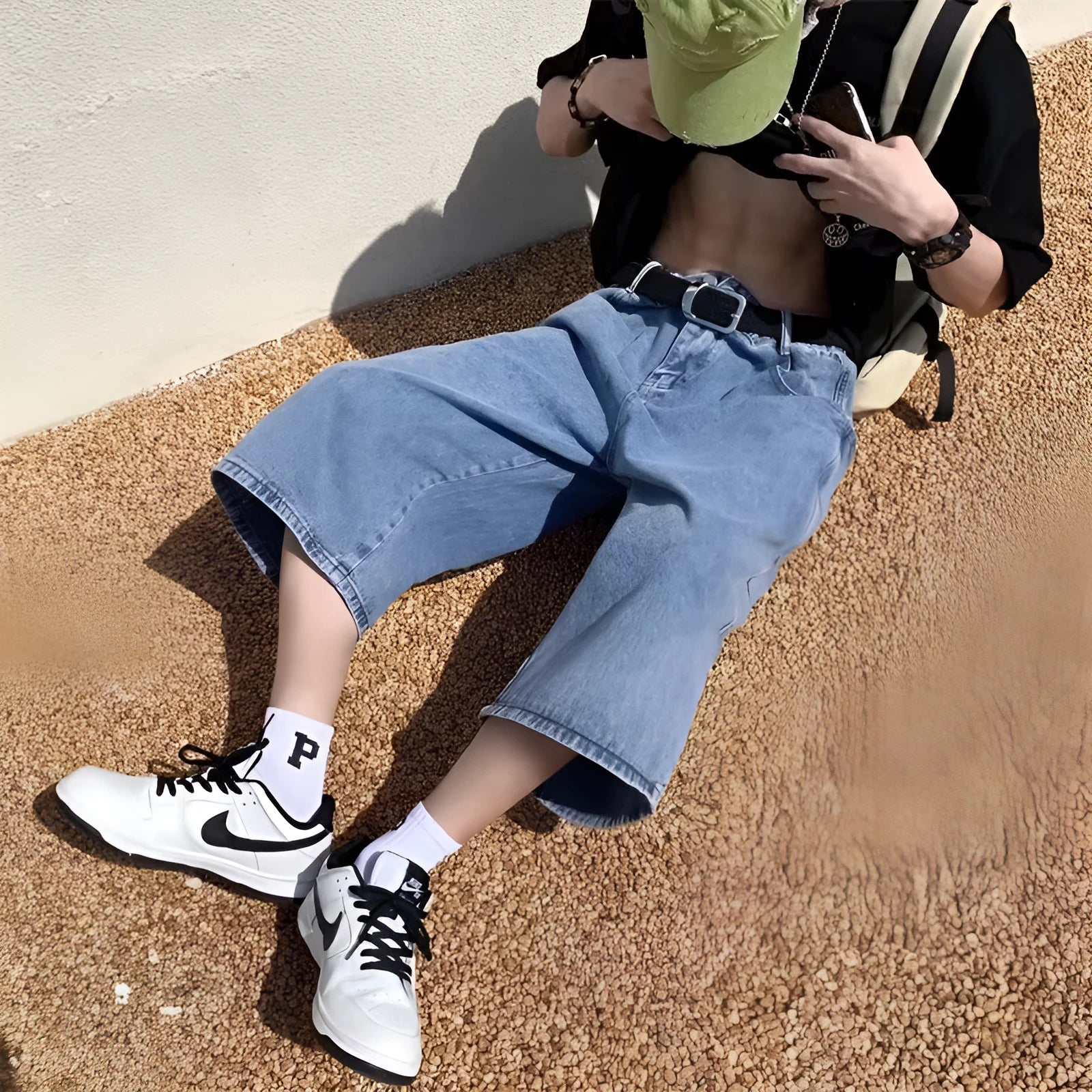 Men's washed blue denim pirate shorts with high waist and cropped length on a plain background.