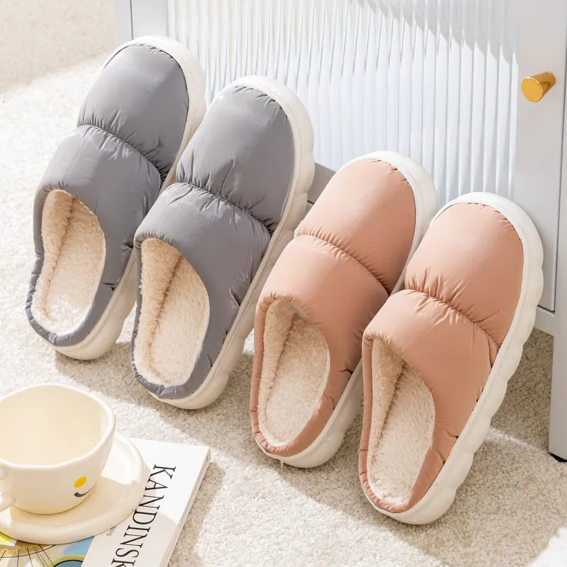 Pair of thick-soled winter slippers with artificial leather upper and plush lining, shown in a choice of colours.