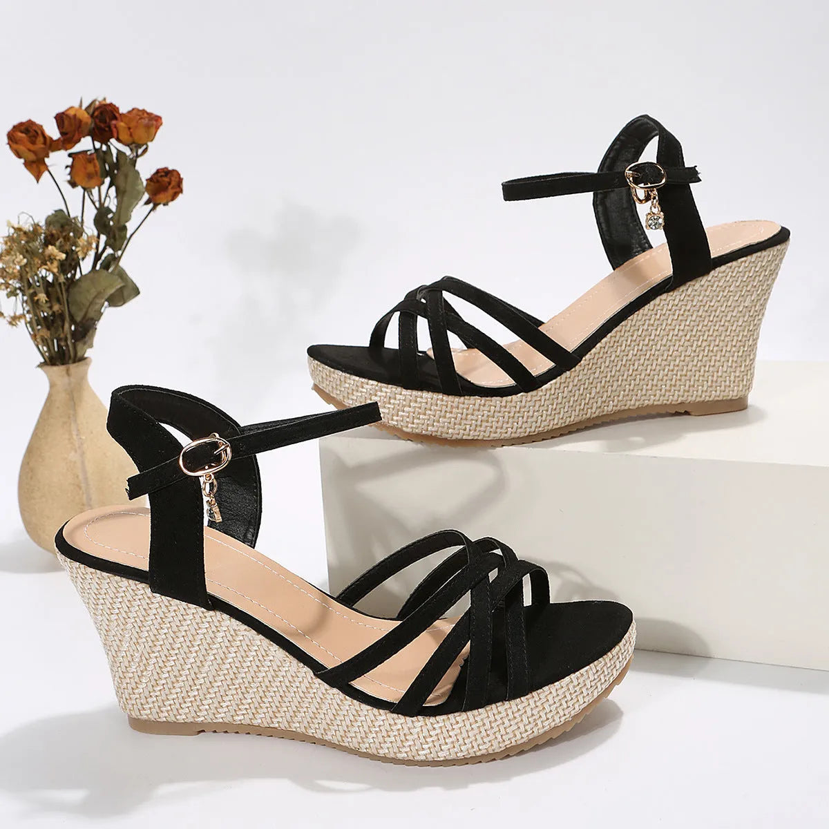 Women's beige cloth wedge sandals with a fish mouth toe design on a plain background.