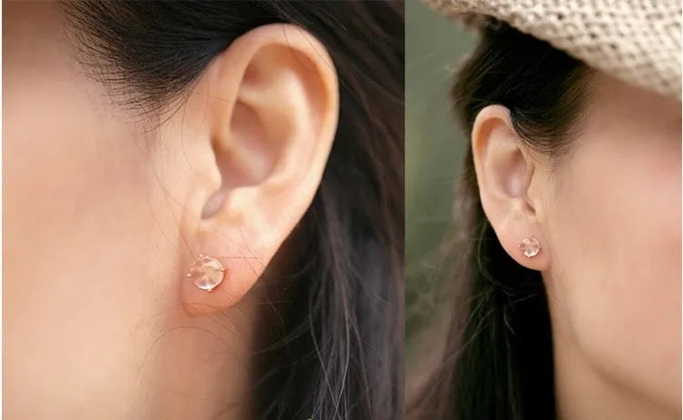 Rose gold drop shape stud earrings with synthetic ross quartz crystal inlay.