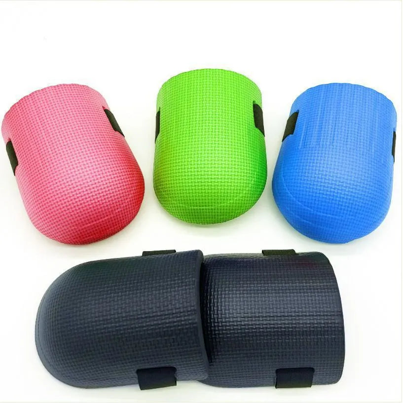 A pair of thick EVA foam kneepads in blue, shown on a hard floor surface.