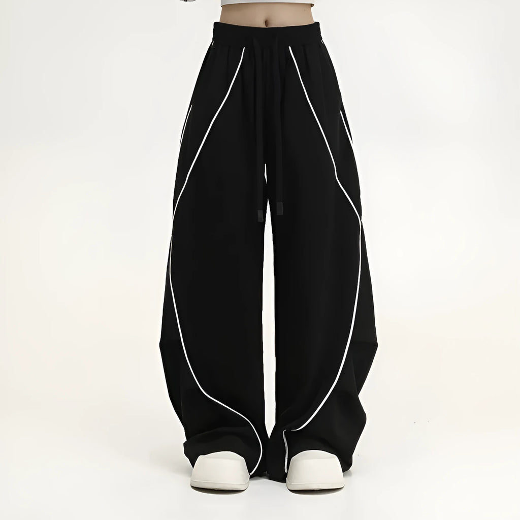 Black and white striped pleated wide-leg hip hop pants on a neutral background