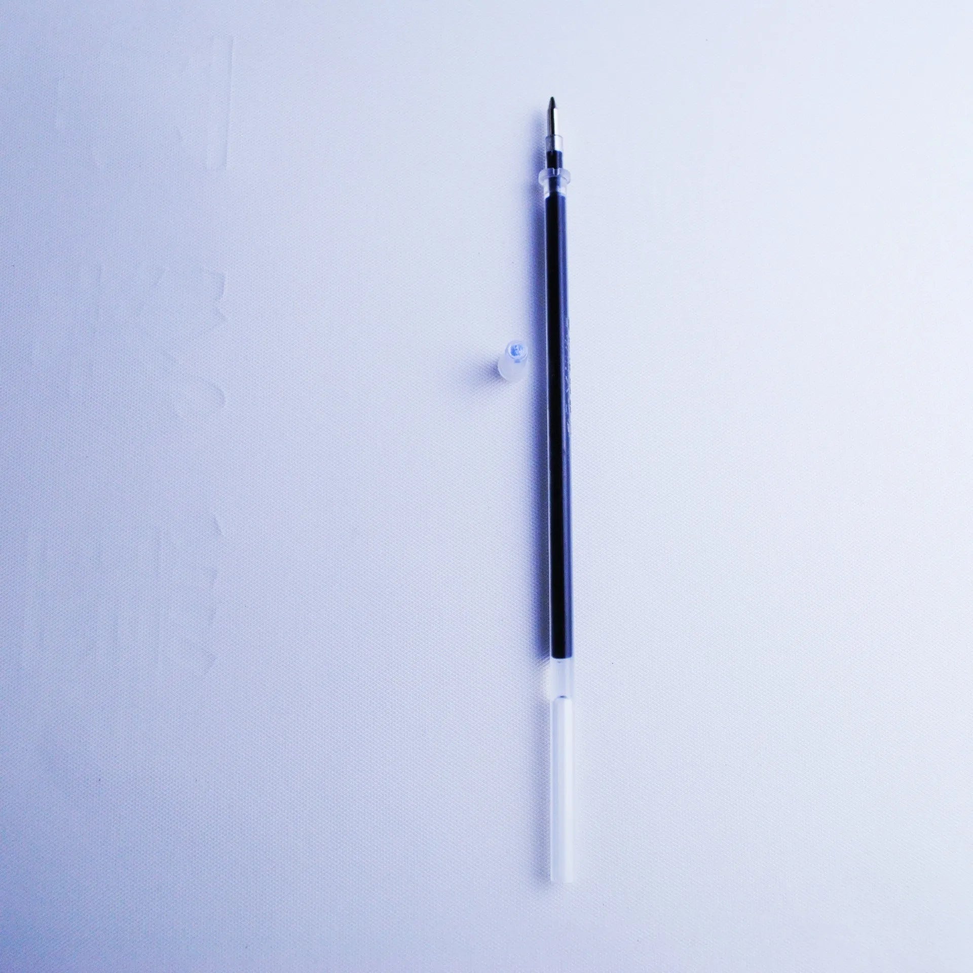 Blue automatic fading pen set with eight refills and pen holder showing 0.5mm tip