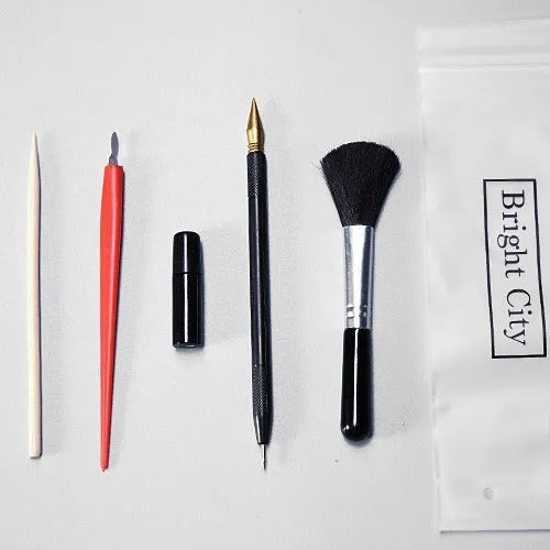 Scratch painting tools set showing healing pen, scrapers, brushes and spray paint for card artwork