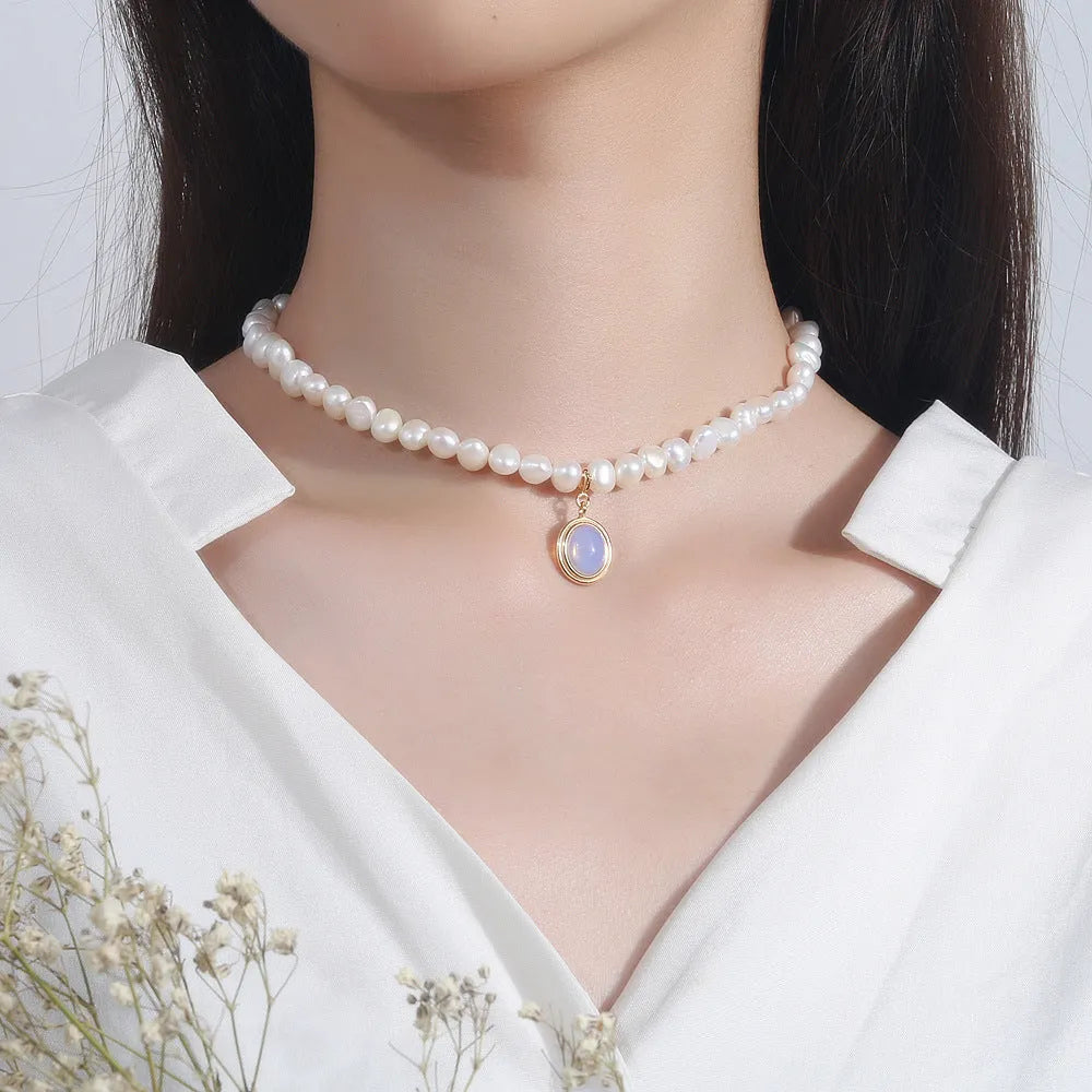 Round medal pearl necklace with geometric silver pendant and irregular freshwater pearls