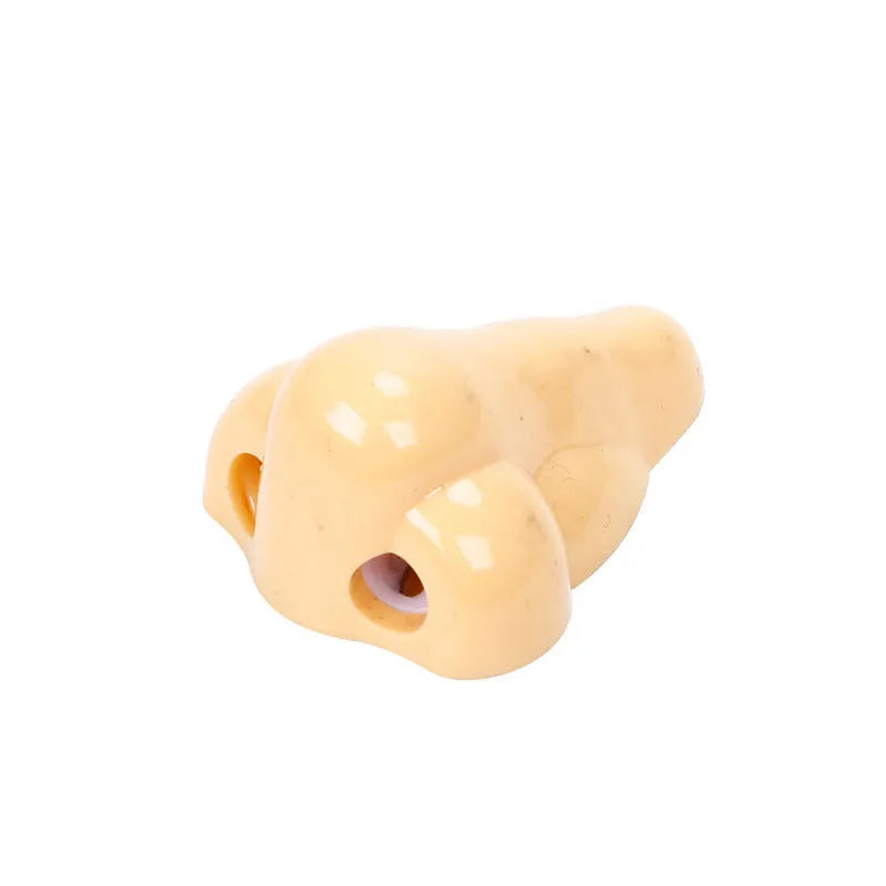 Flesh-coloured geometry-shaped pencil sharpener with big nostril design measuring 58x45x30mm