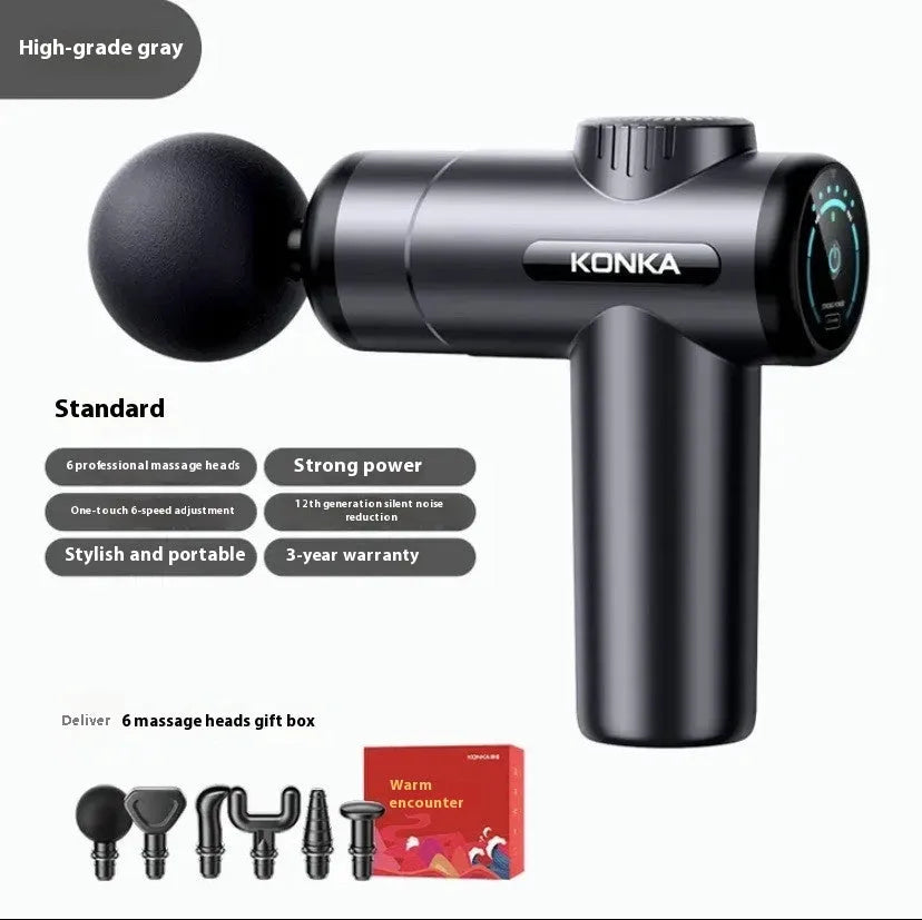Konka V19 grey mini electric massage gun with multiple attachment heads on a table