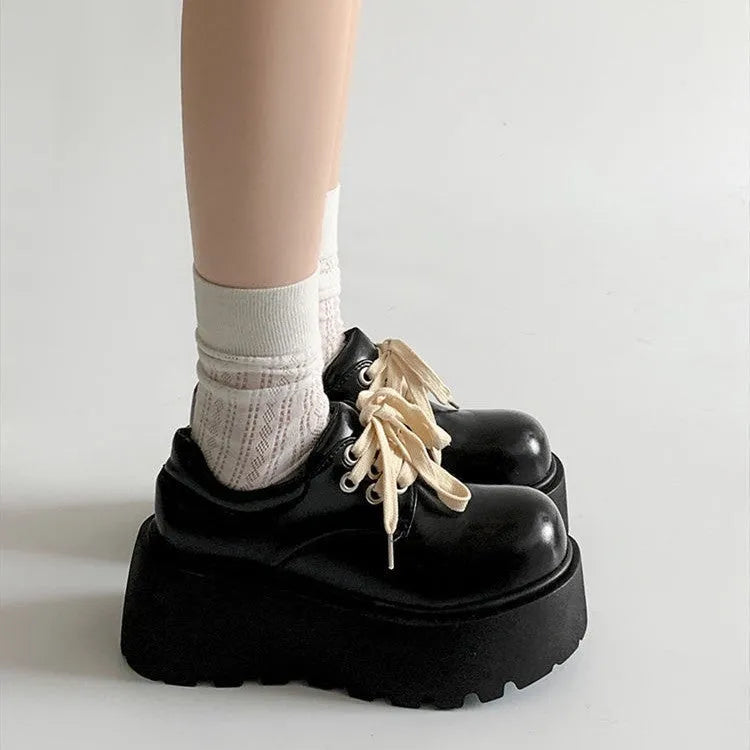 Women's matte black lace-up shoes with a chunky 6-8cm heel and thick rubber sole.