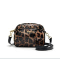 Leopard print crossbody phone bag with PU finish, zip pocket, and 120 cm shoulder strap on neutral background