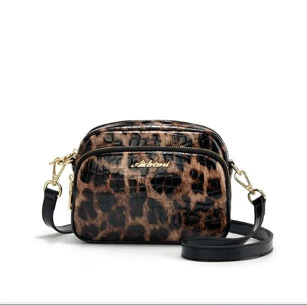 Leopard print crossbody phone bag with PU finish, zip pocket, and 120 cm shoulder strap on neutral background