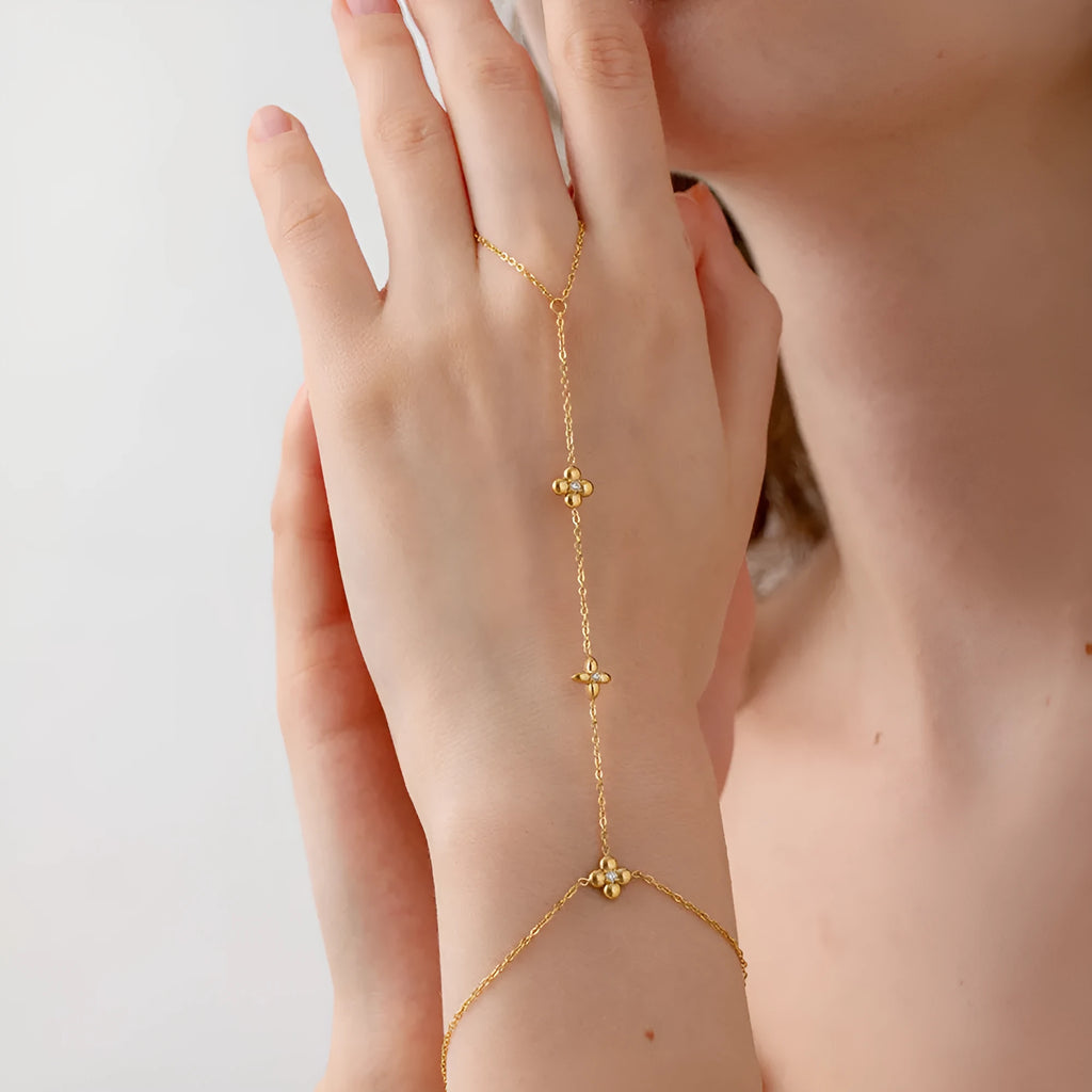 Gold-tone stainless steel women's bracelet with an eight-pointed star and floral geometric design