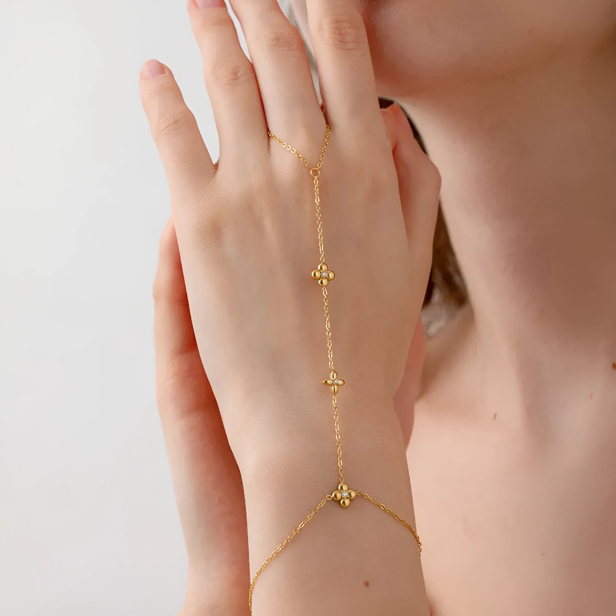 Gold-tone stainless steel women's bracelet with an eight-pointed star and floral geometric design