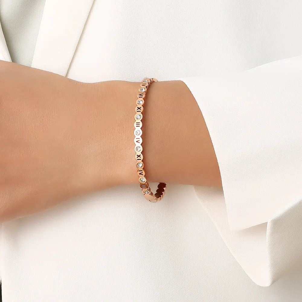 Korean style titanium steel bracelet with a numeric charm, shown in gold, rose gold, and steel colour options.