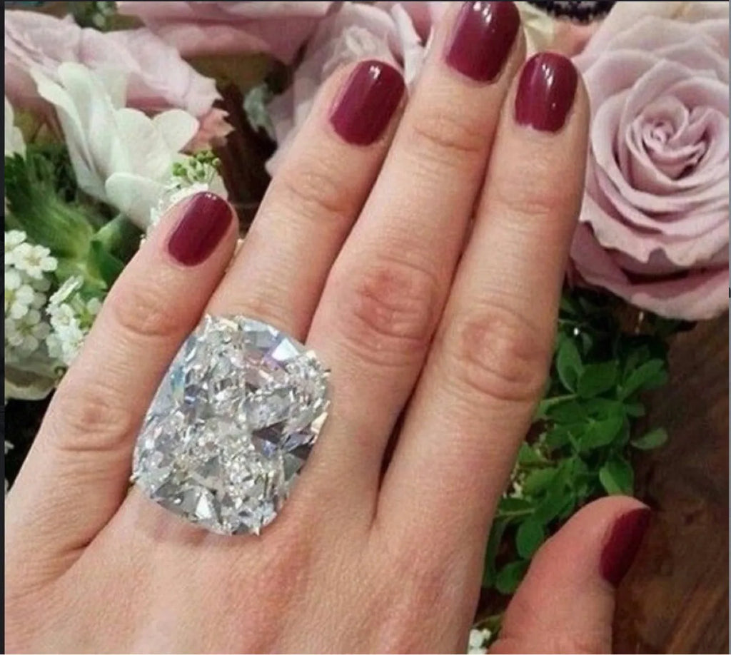 Simple inlaid white square diamond ring on a geometric alloy band with a white gold colour finish.