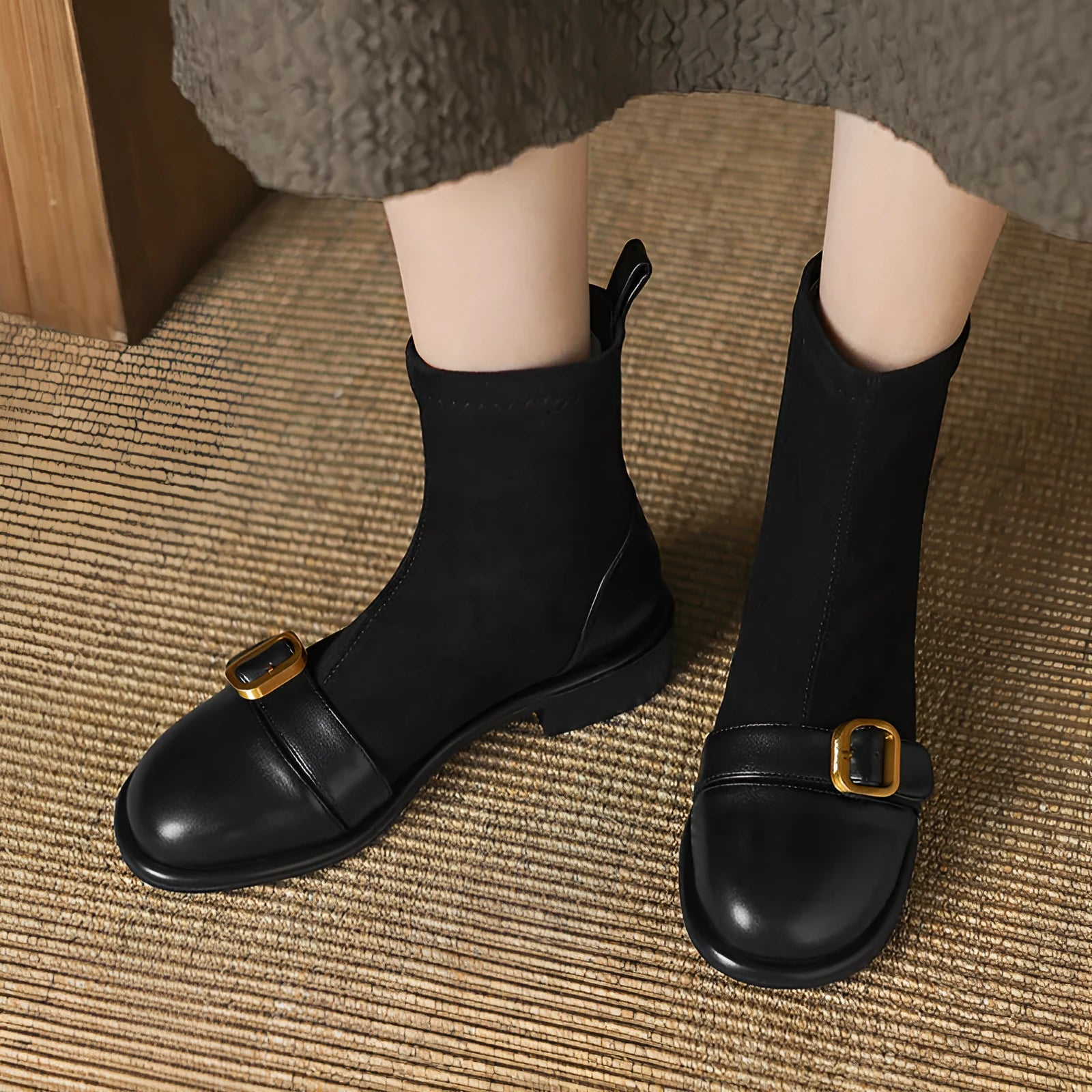 Women's black low heel Martin boots with belt buckle stitching and front lace-up closure on a round toe.