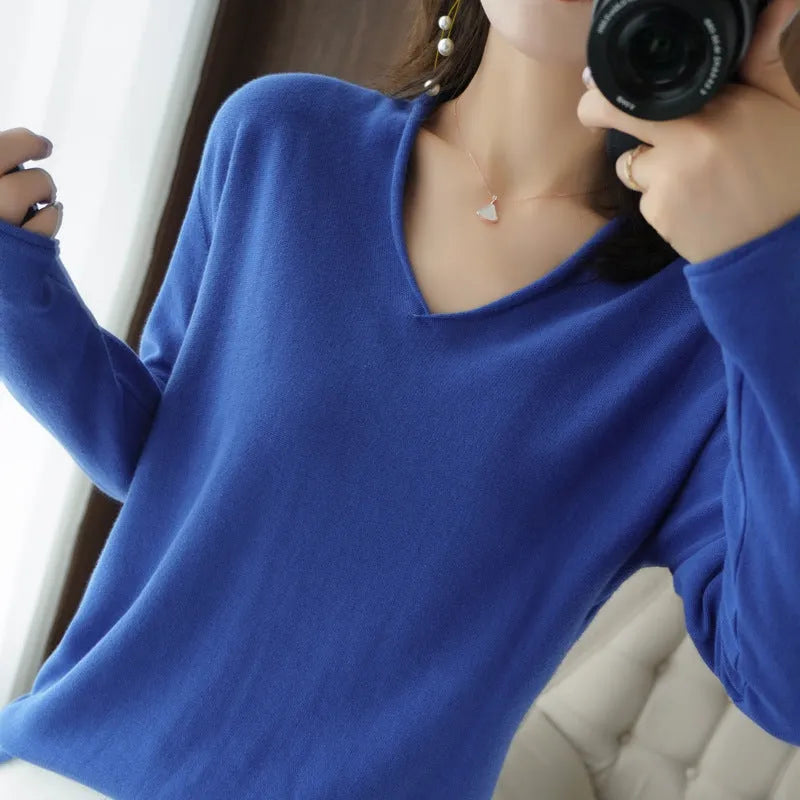 Women's V-neck long sleeve knitwear pullover top in a macaron colour on a hanger.