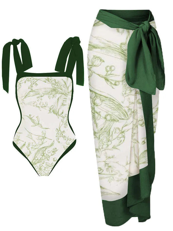 Women's floral print two-piece swimsuit with a blue chiffon skirt laid flat.