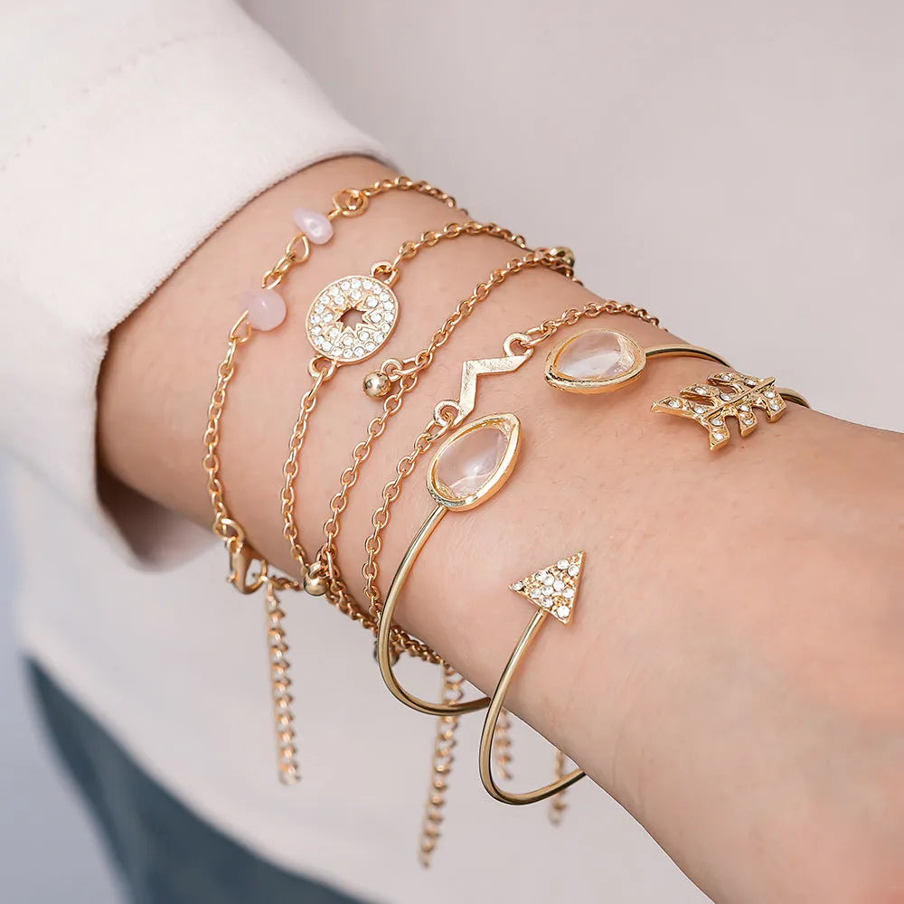 Golden bracelet charm set with six pieces including V-shape, arrow, water drop and drill spot designs