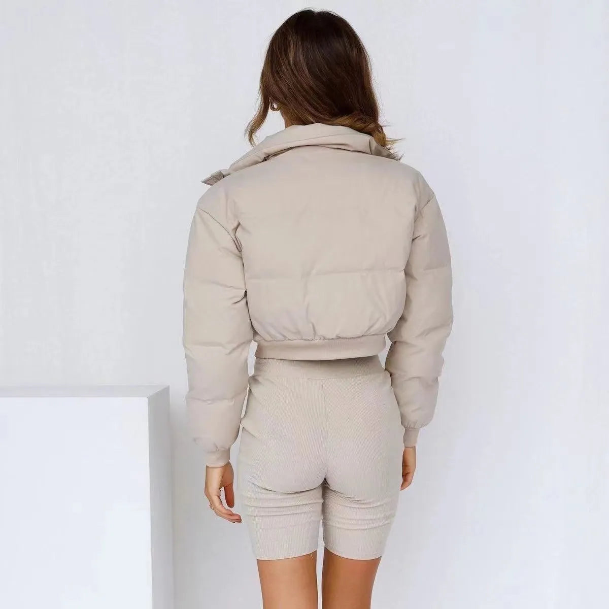 Blue loose fit polyester jacket for women with long sleeves on a hanger.