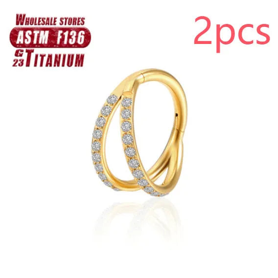 Titanium alloy nose ring on a plain background, shown in silver and gold finishes.