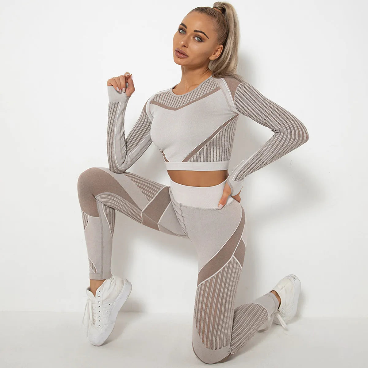 Women's black seamless knitted long-sleeved yoga wearsuit with stripe pattern, shown in a yoga pose.