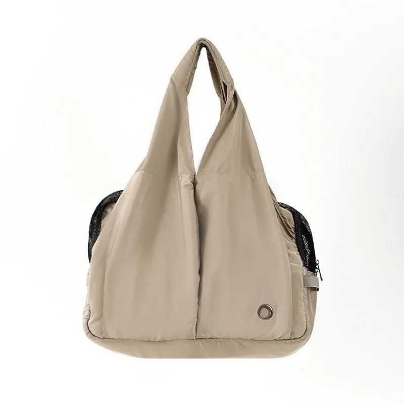 Apricot coloured cloth pet carrier handbag for small dogs or cats, showing carrying handles.
