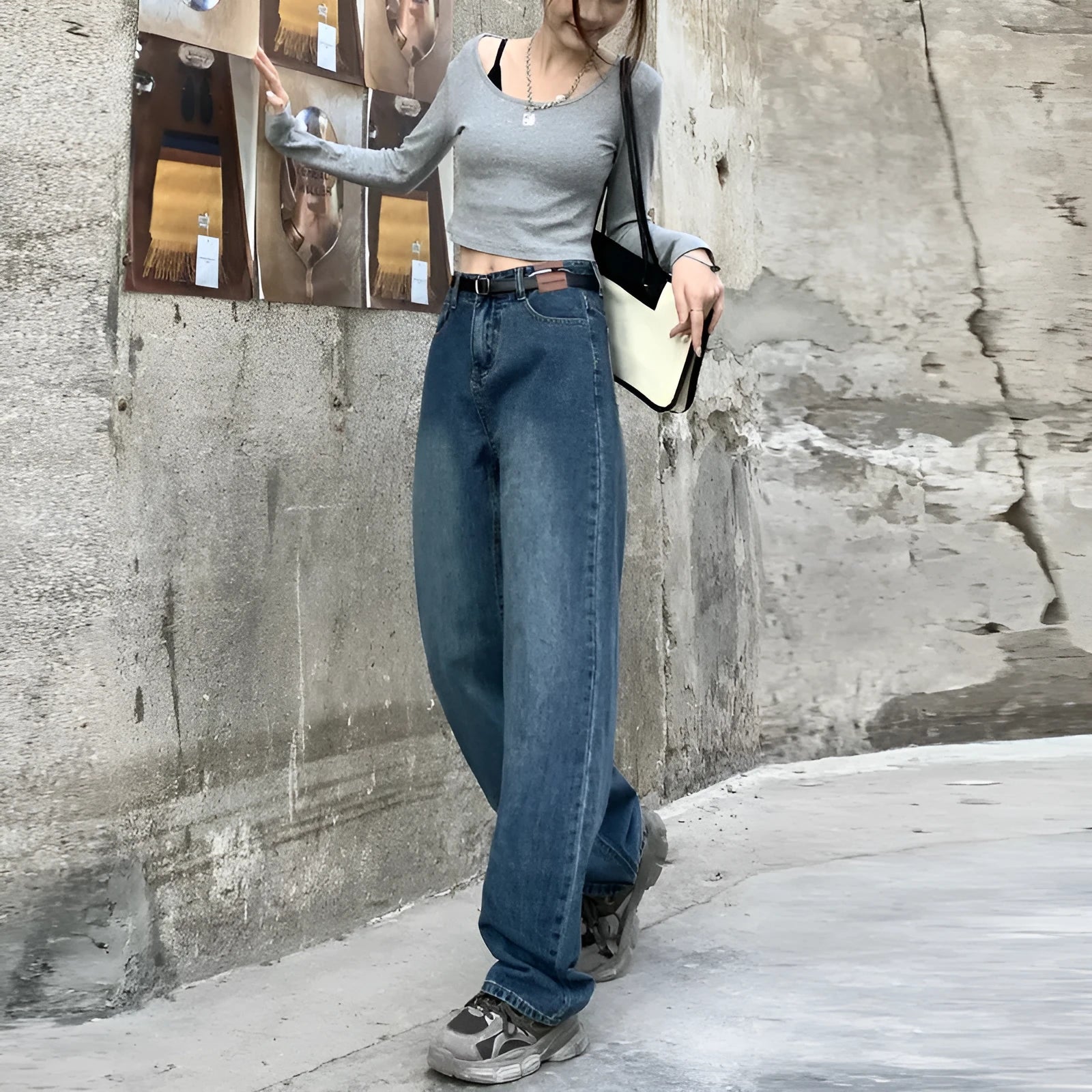 Women's retro blue high-waisted straight-leg jeans on a hanger, showing front detail.