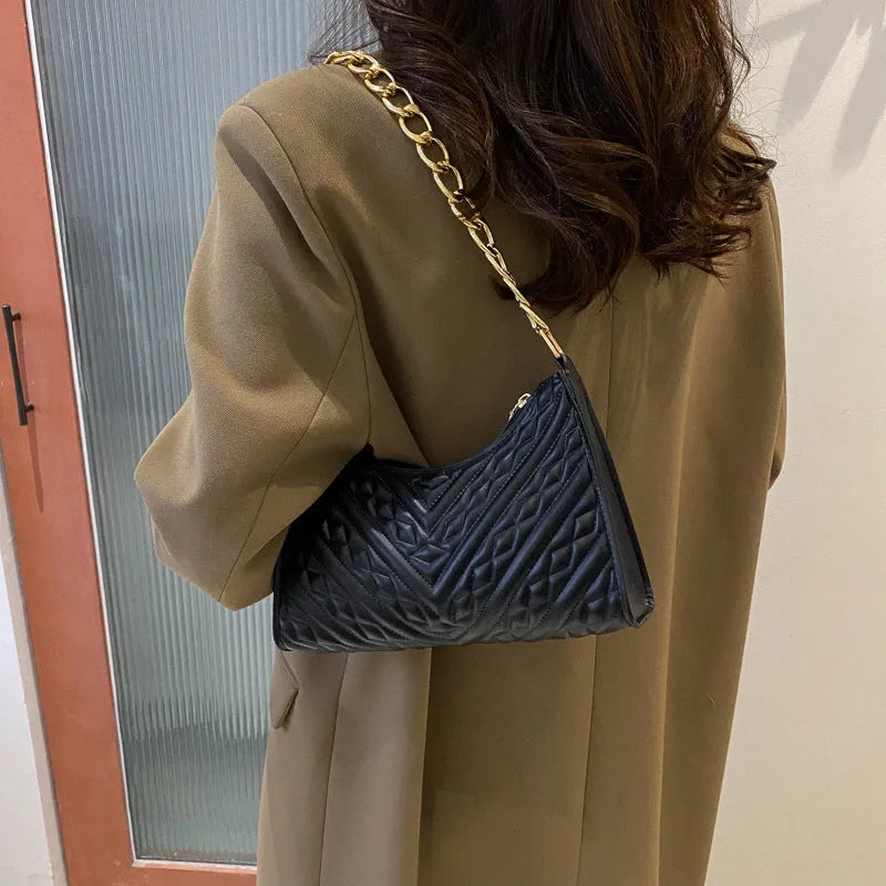 Brown pleated chain shoulder bag showing vertical square shape and adjustable strap