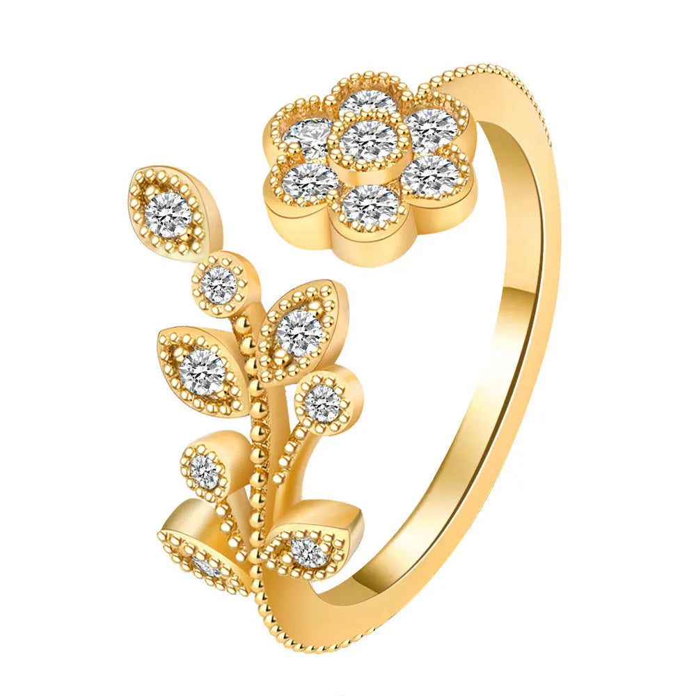 Women's open ring with diamond flower and leaf pattern in copper, shown in gold and white colour options.