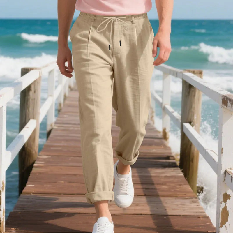 Men's light beige linen casual trousers with drawstring waist and straight-leg fit on a hanger.