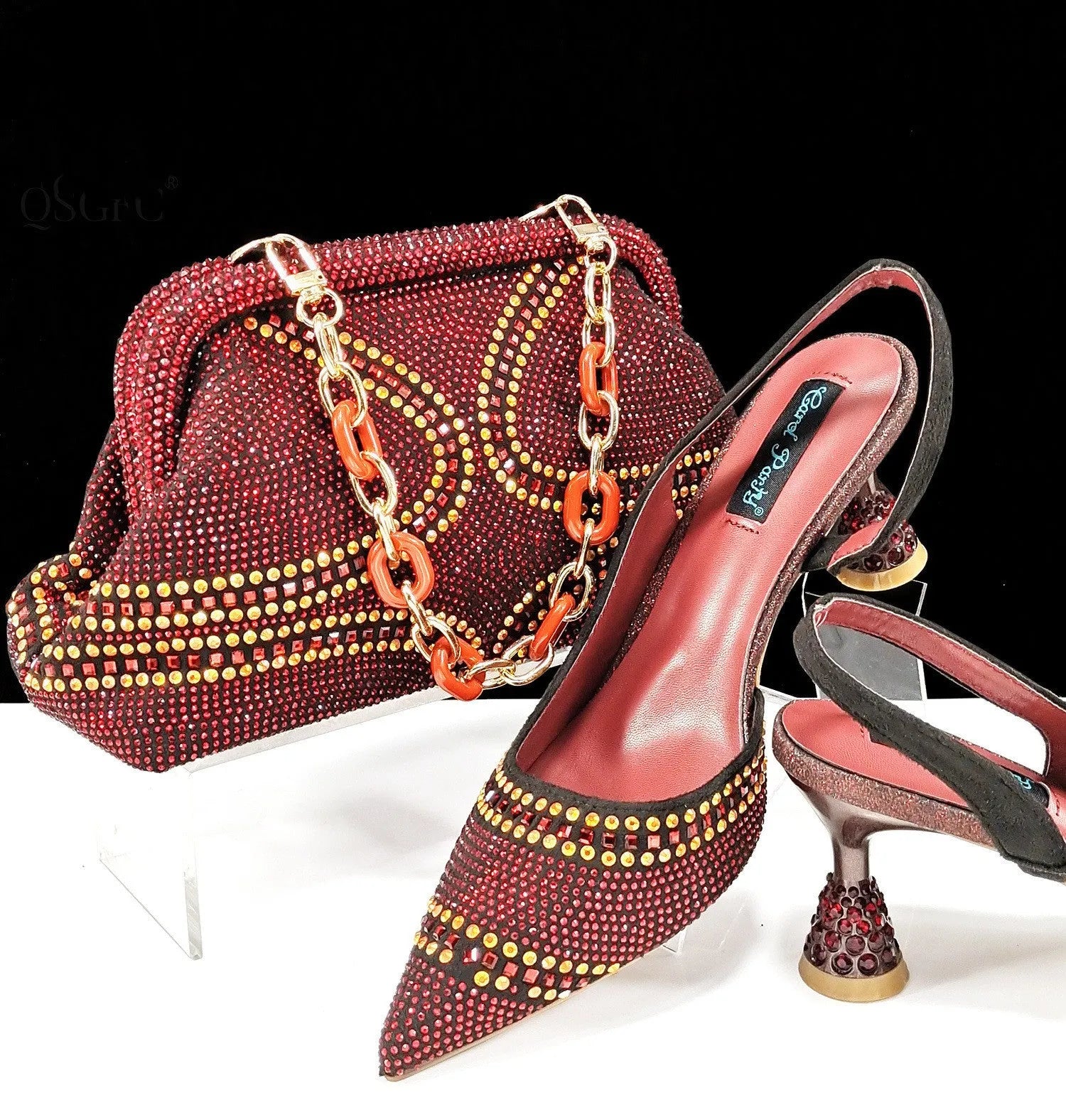 Women's pink pointed toe high heel shoes with rhinestones and a matching small clutch bag.