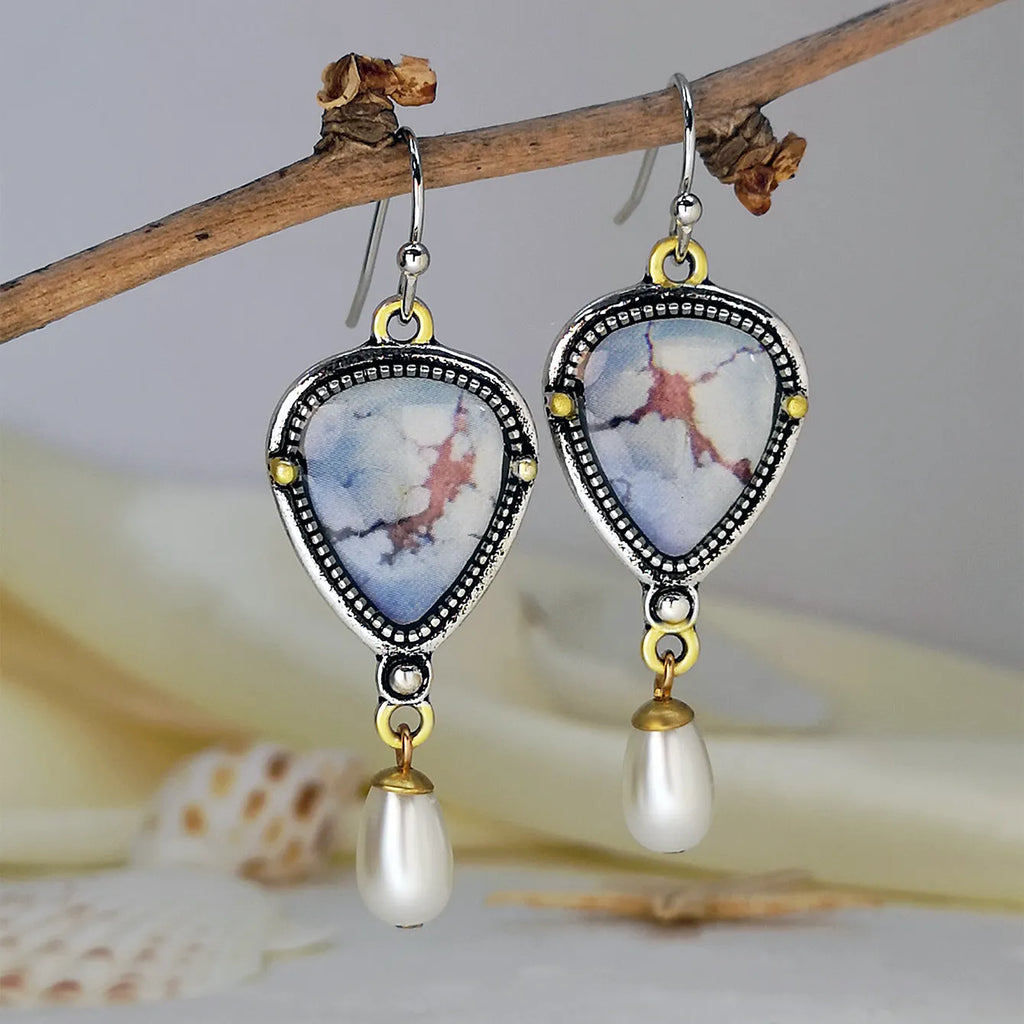 Retro blue geometric drop earrings with synthetic opal and white pearl details on electroplated metal.