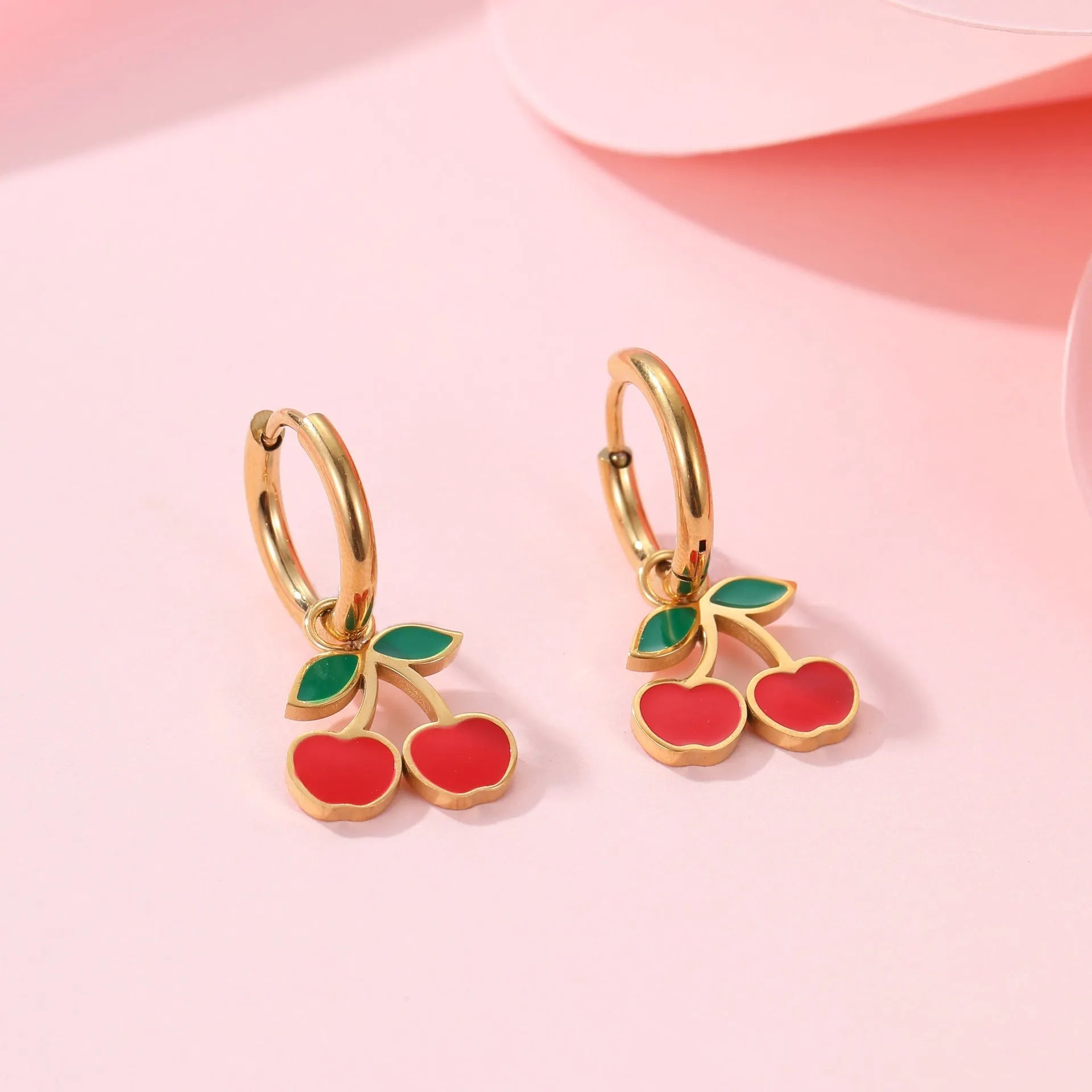 Cherry jewellery set showing necklace, bracelet, earrings, and ring in stainless steel with 18K electroplated finish