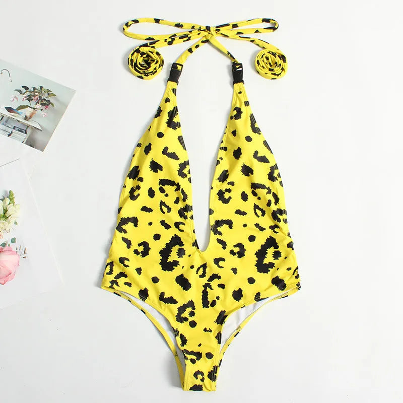 Women's leopard print one-piece bandage swimsuit with buckle detail, shown in a backless design.