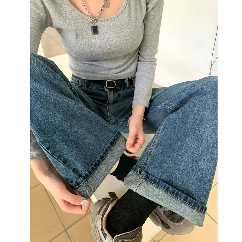 Women's retro blue high-waisted straight-leg jeans on a hanger, showing front detail.