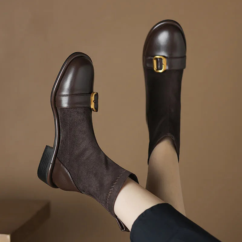 Women's black low heel Martin boots with belt buckle stitching and front lace-up closure on a round toe.